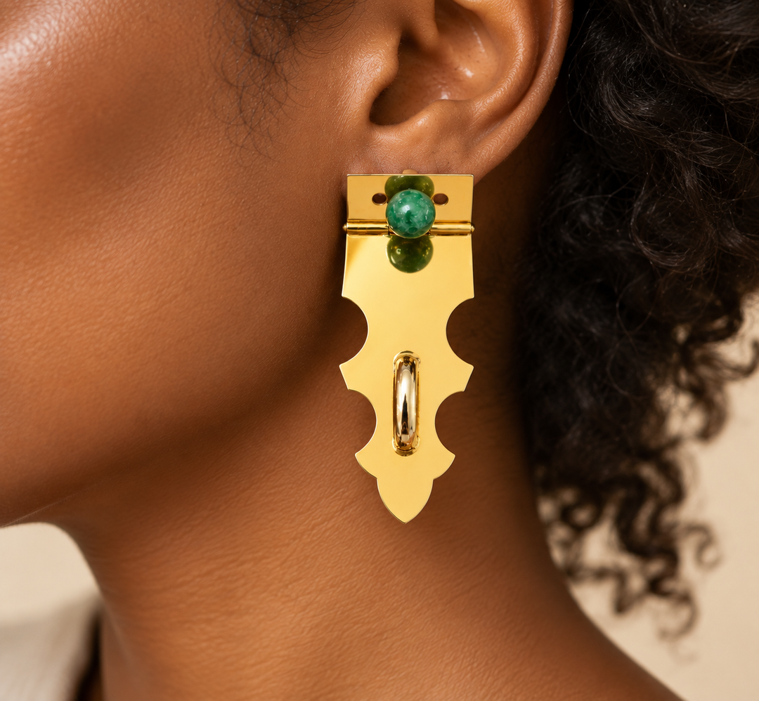 Handmade gold-plated statement earrings with green stone and sculptural raised details