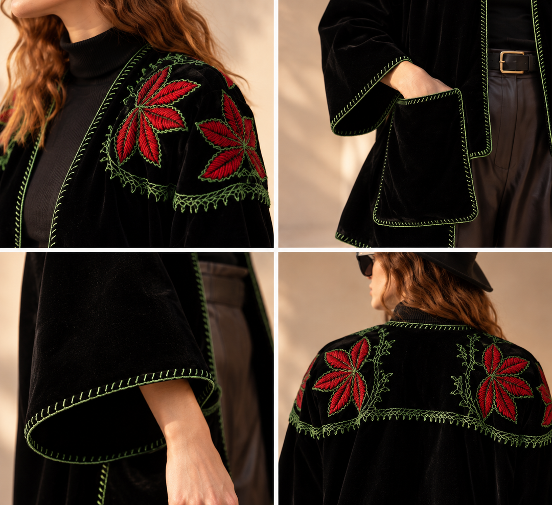 Close-up details of a handcrafted black velvet coat featuring intricate red floral embroidery, green hand-stitched edging and artisan-finished details.