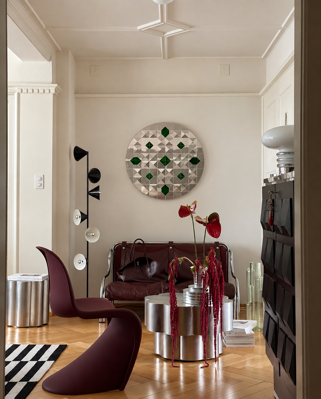 Handcrafted Persian Ayneh Kari mirror art with green glass accents displayed in a contemporary living room.