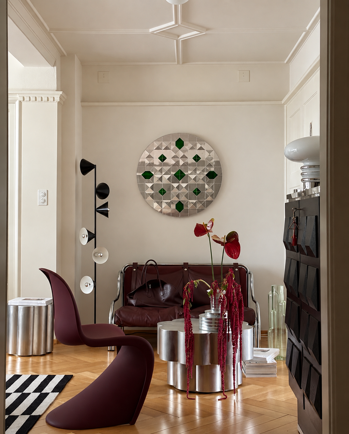 Handcrafted Persian Ayneh Kari mirror art with green glass accents displayed in a contemporary living room.