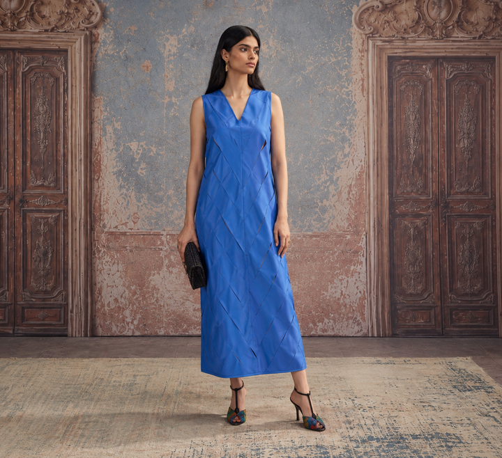 Full-length blue sleeveless maxi dress with V-neck and geometric cutout details