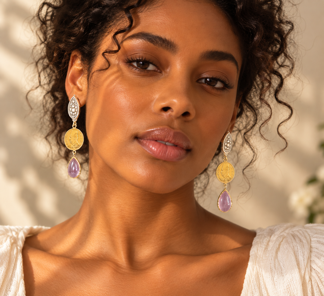 Handmade statement drop earrings with gold-tone coin details, silver-tone floral tops and light pink teardrop accents worn on a model