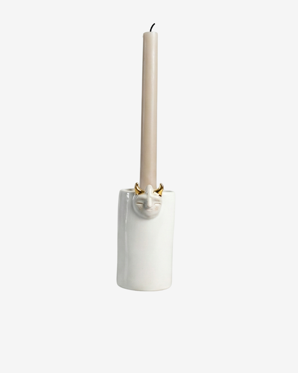 White ceramic candle holder with a beige candle on a white background