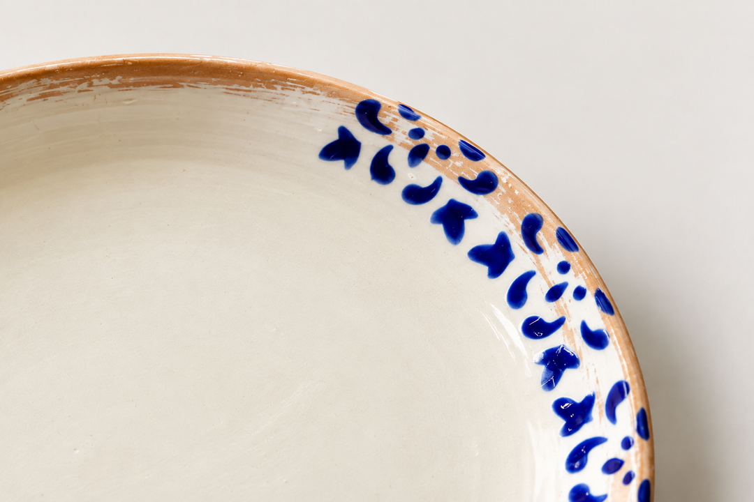 Close-up of cobalt blue hand-painted details on handmade glazed ceramic plate