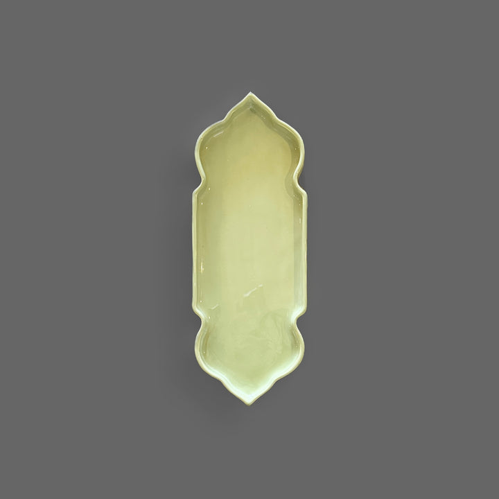 Pastel green handcrafted ceramic serving tray with an elegant sculptural shape