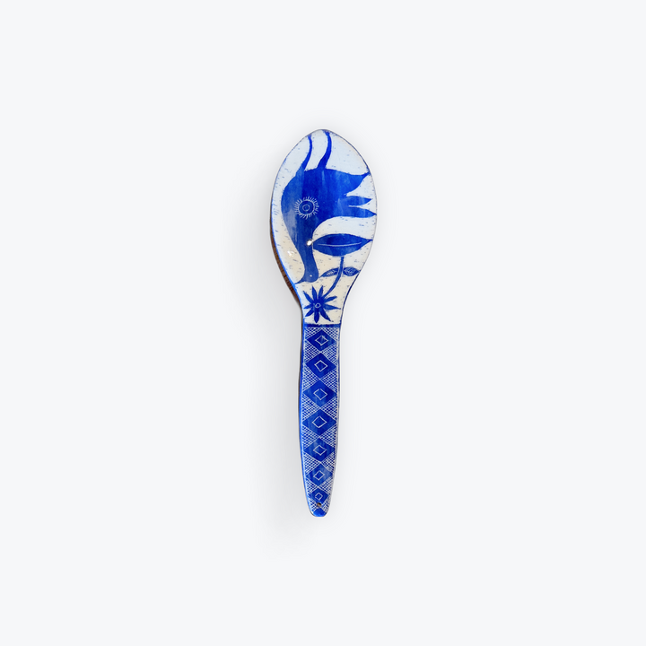 A blue and white decorative spoon featuring a stylized bird design on the bowl and a geometric diamond pattern on the handle, set against a plain white background.