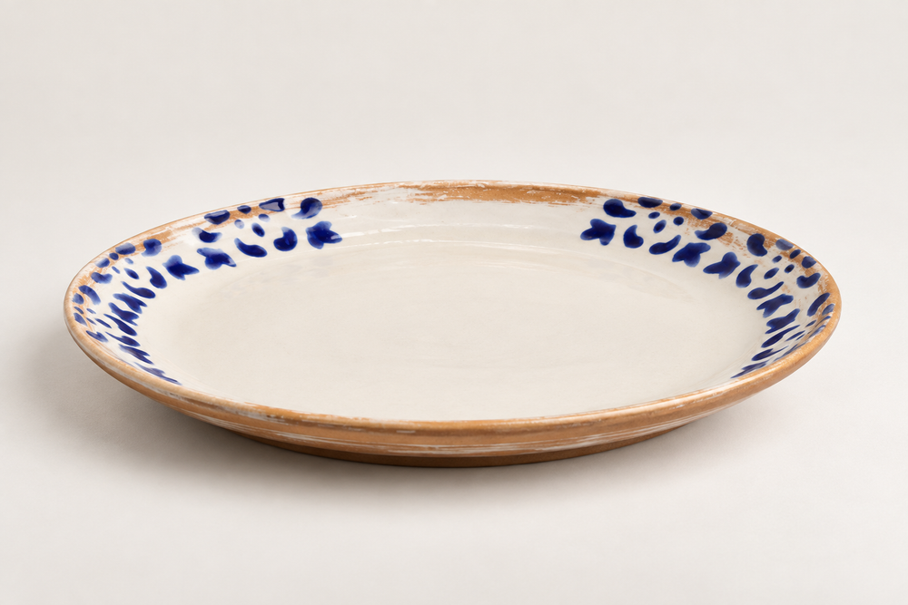 Side view of handmade 22 cm ceramic plate with cobalt blue hand-painted details