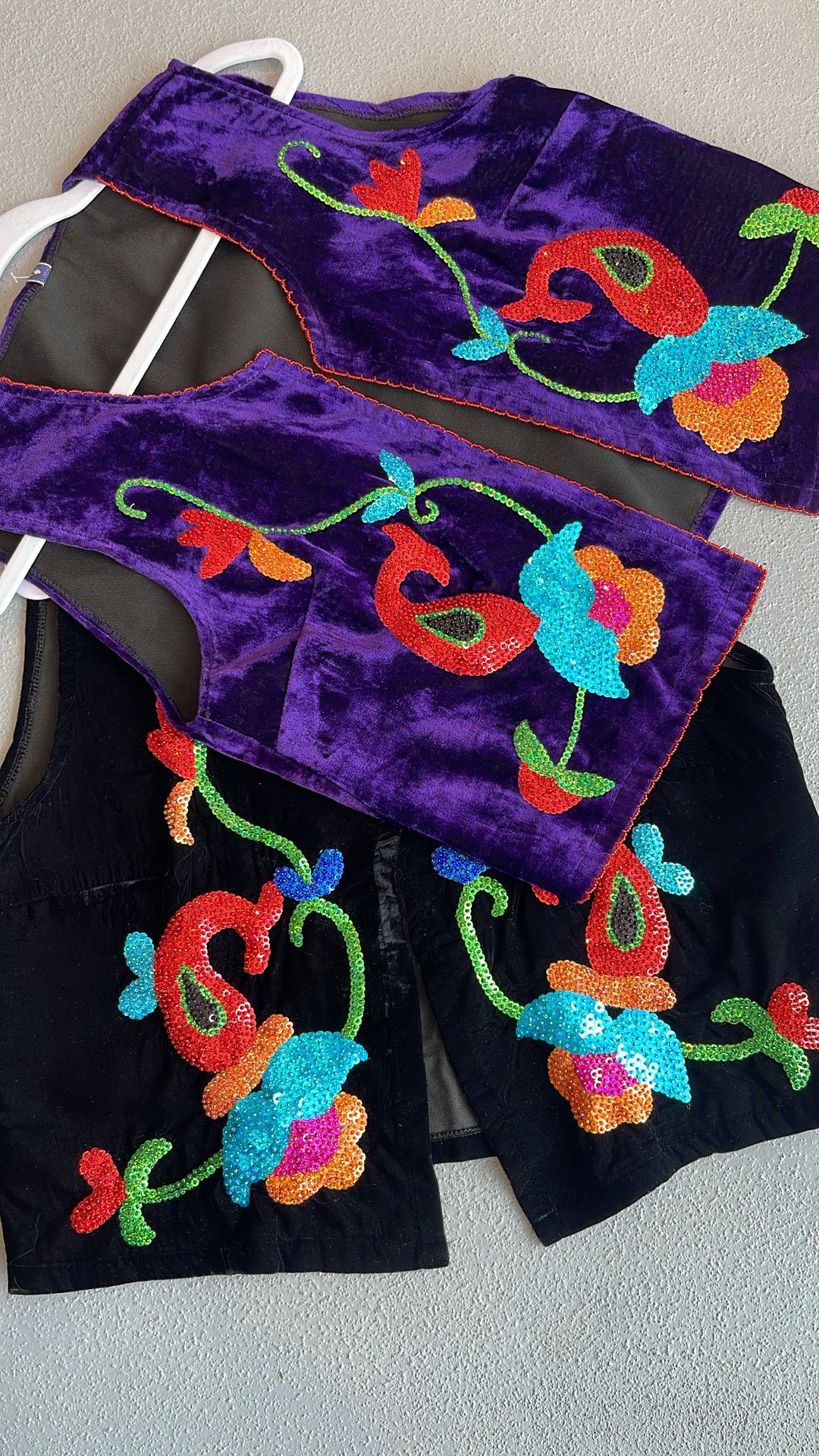 Two embroidered fabric pieces on a white background