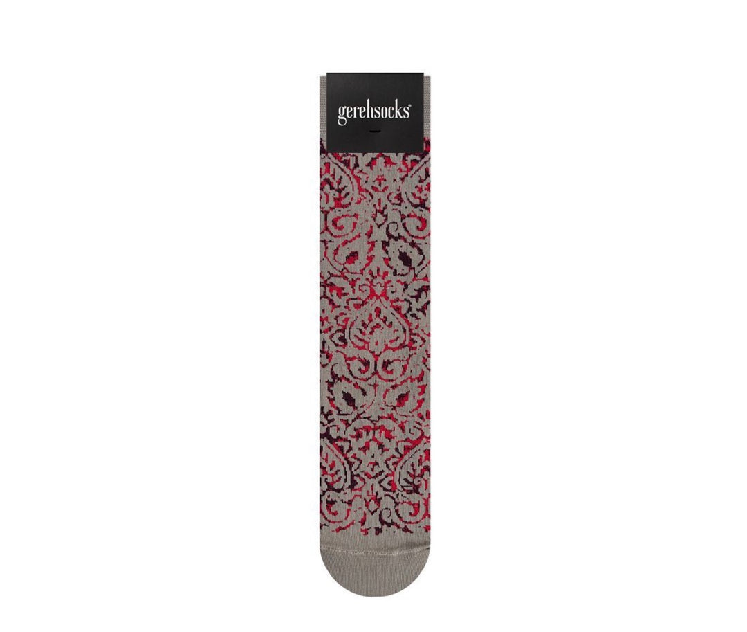 A single sock with a red, black, and gray damask pattern, displayed vertically on a white background with its black paper header card showing the brand 'gerehsucks'.