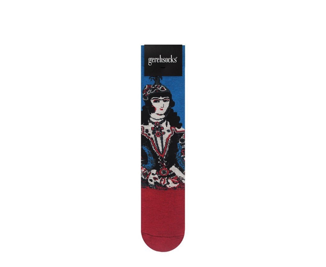 A single Gerdloesock sock featuring a graphic illustration of a woman in a red and white patterned dress against a blue background, with a solid dark red toe and heel.