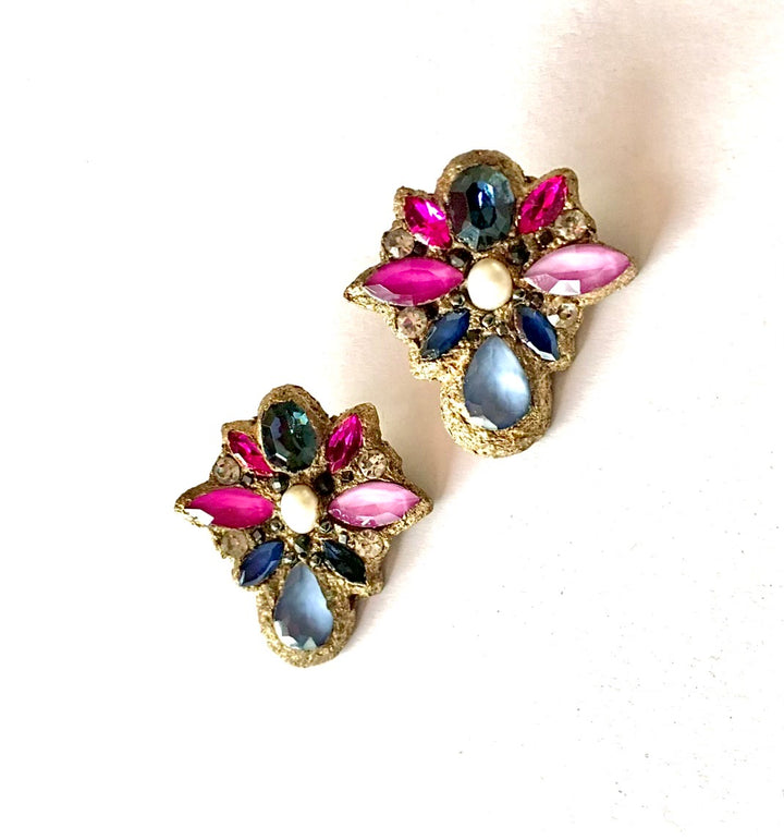 A pair of vintage-style gold-tone floral earrings embellished with pink, blue, and green rhinestones, displayed on a clean white background.