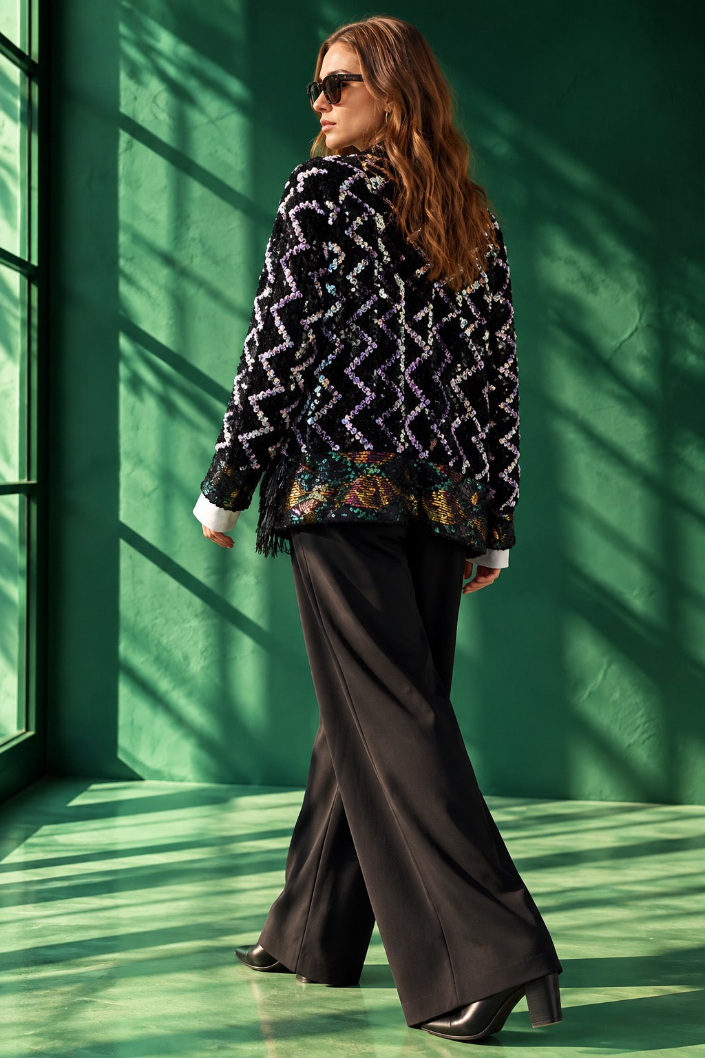 Alt Text:
Back view of the Zig Zag handcrafted black jacket by Siahkar, featuring intricate hand-sewn iridescent sequins and statement artisan detailing.