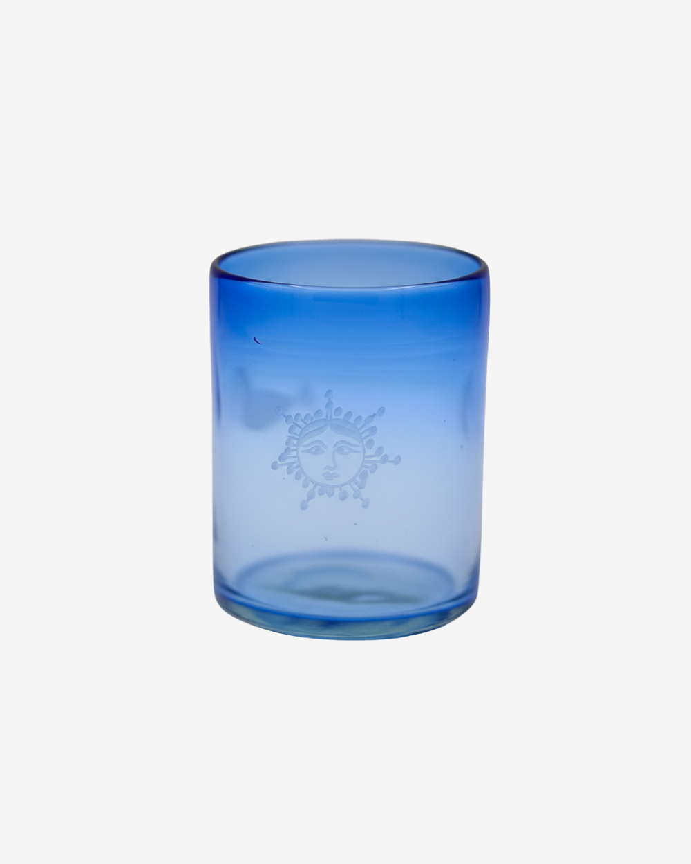 Blue glass tumbler with a sun design on a white background